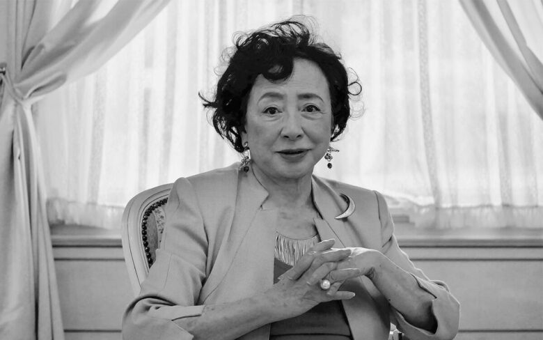 有馬稲子さんが取材に応じている様子のモノクロ写真